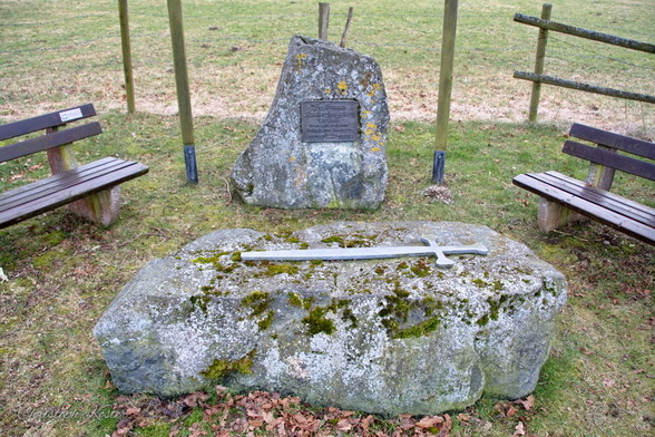 Monument at the site of the free court in Assinghausen with a sword on the judgement stone.