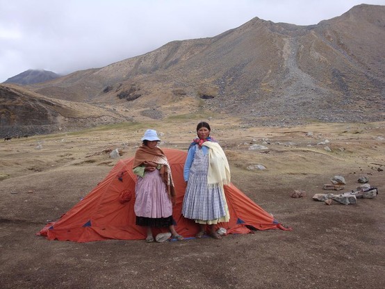 these two young women from the base village hire out as porters. they slung 25-30kg loads over their neck, hanging in front. up steep rocky trail from 4300-5640m. after hour break up there -10C lite wind, they descended back down.