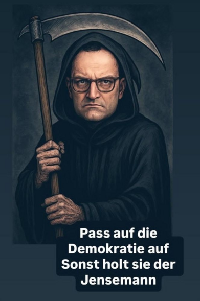 Jens Spahn in schwarzer Kutte mit erhobener Sense.